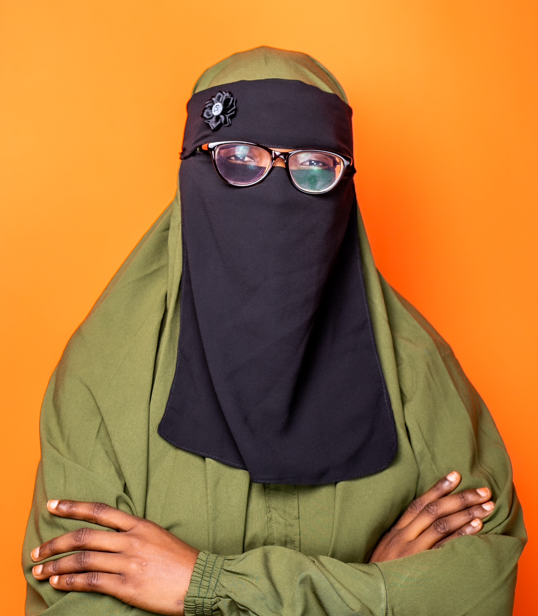 A person wearing glasses and a head covering